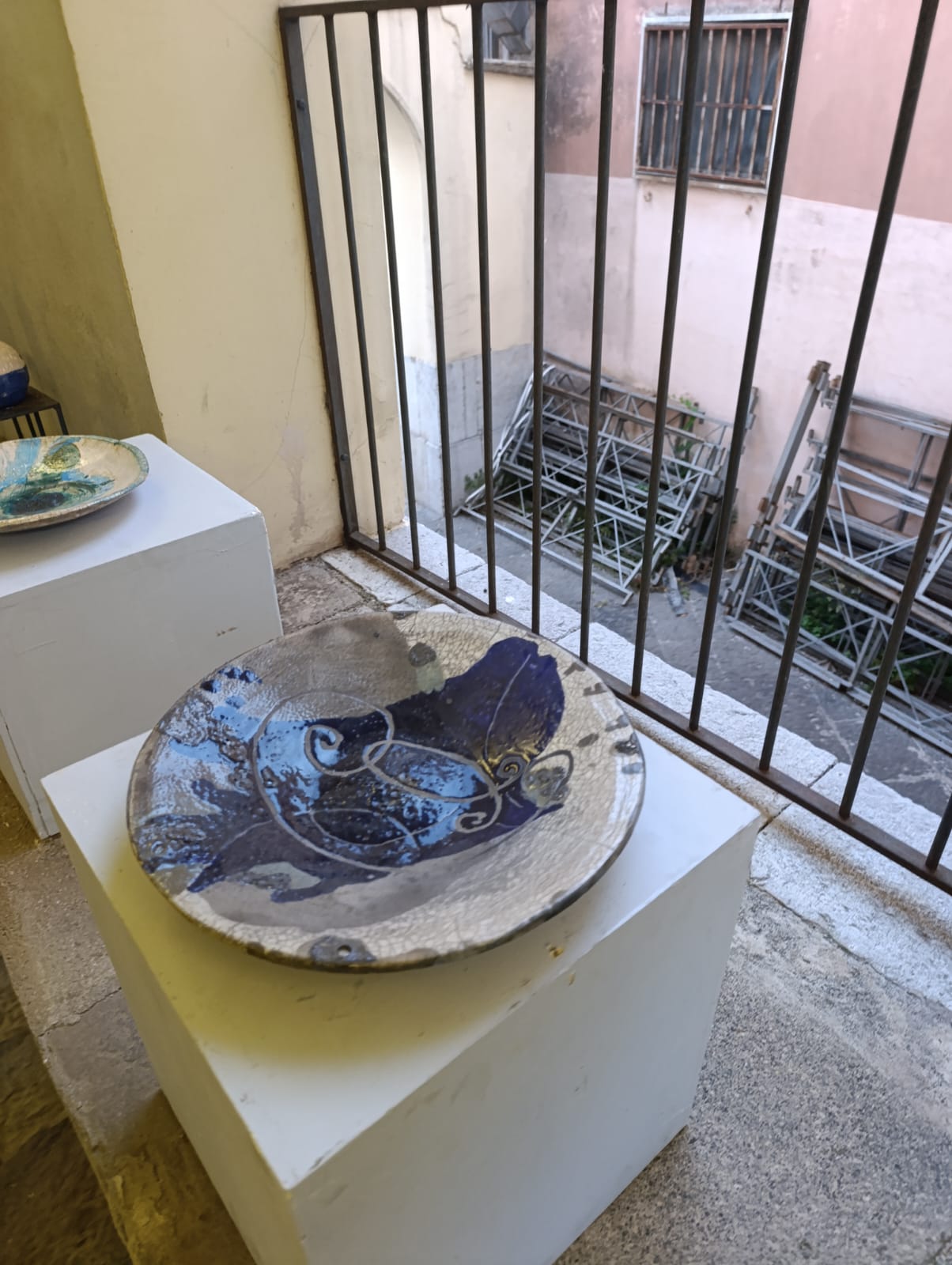 Piatto Raku decorato con motivi blu su base bianca